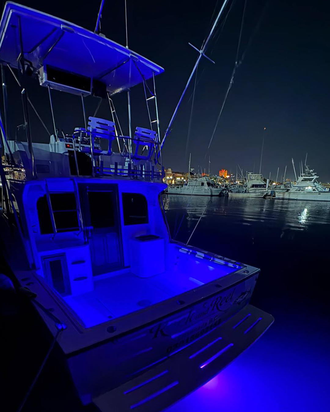 Albemarle 325 at night with blue underwater lights