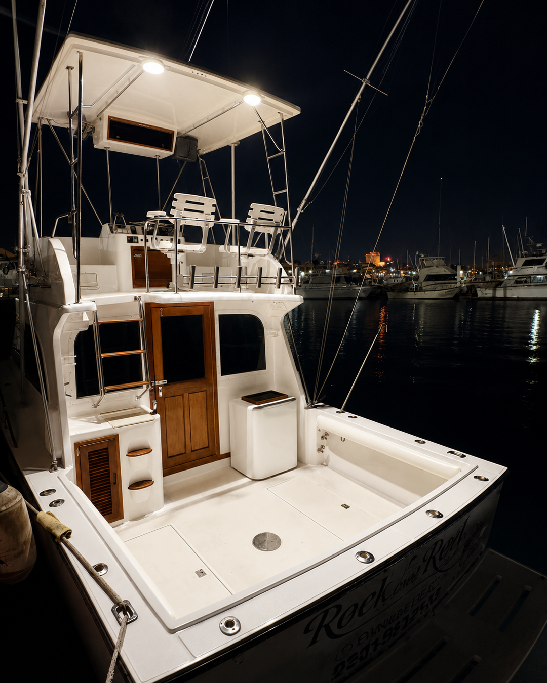 Cockpit at night lit by overhead lights in the marina