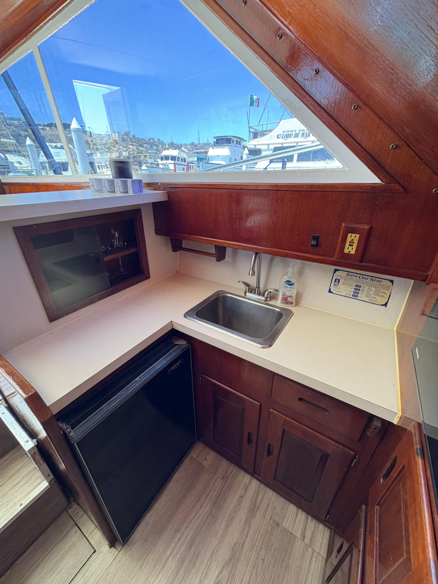 Galley with stainless sink, refrigerator and mahogany joinery