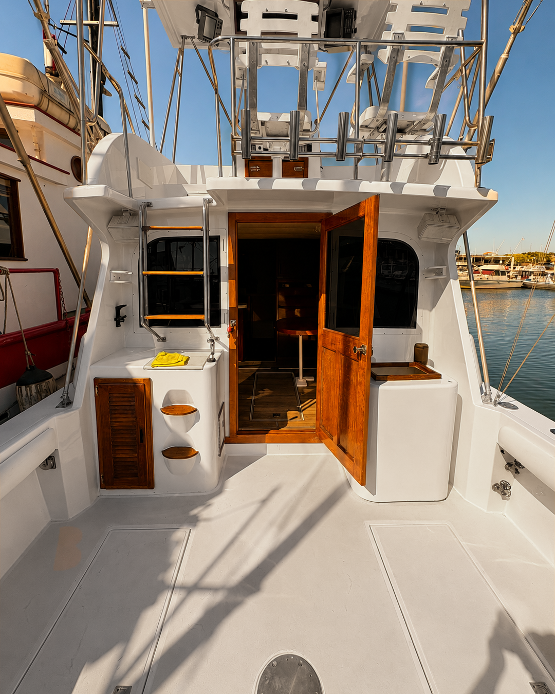 Cockpit with teak salon door open and clean white deck